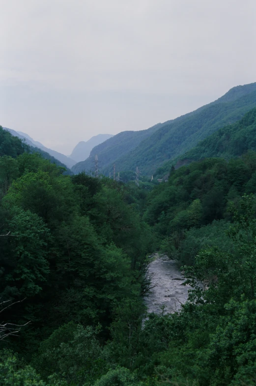 a view of a mountain with some water flowing between it