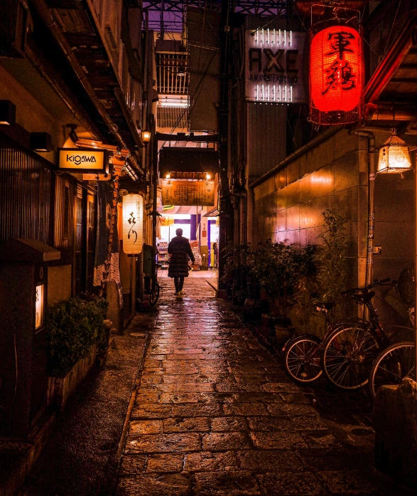 the night has dark buildings and cobblestone walkways