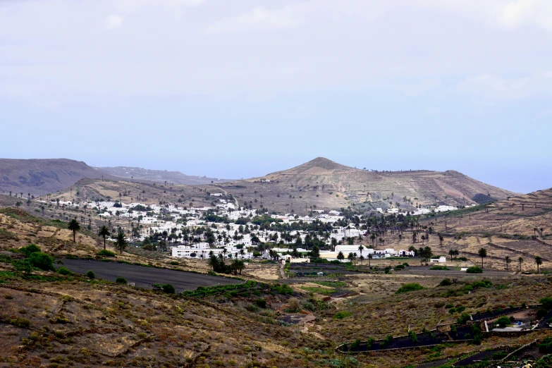 a hilly hillside has many houses and hills