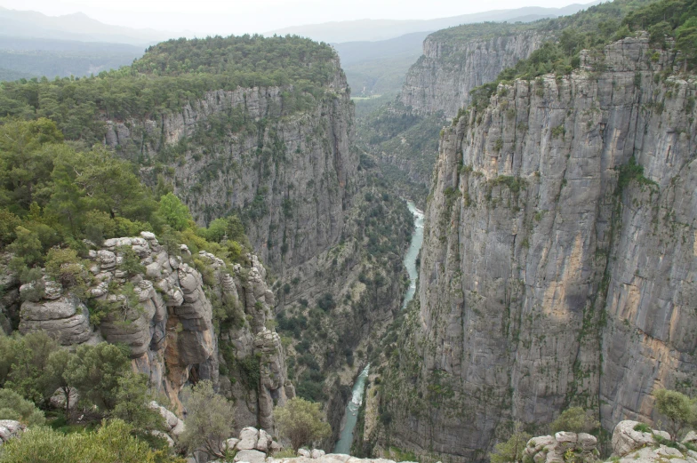 mountains and valleys with a river in the middle