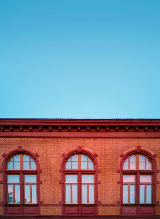 the red building has three arched windows on each side