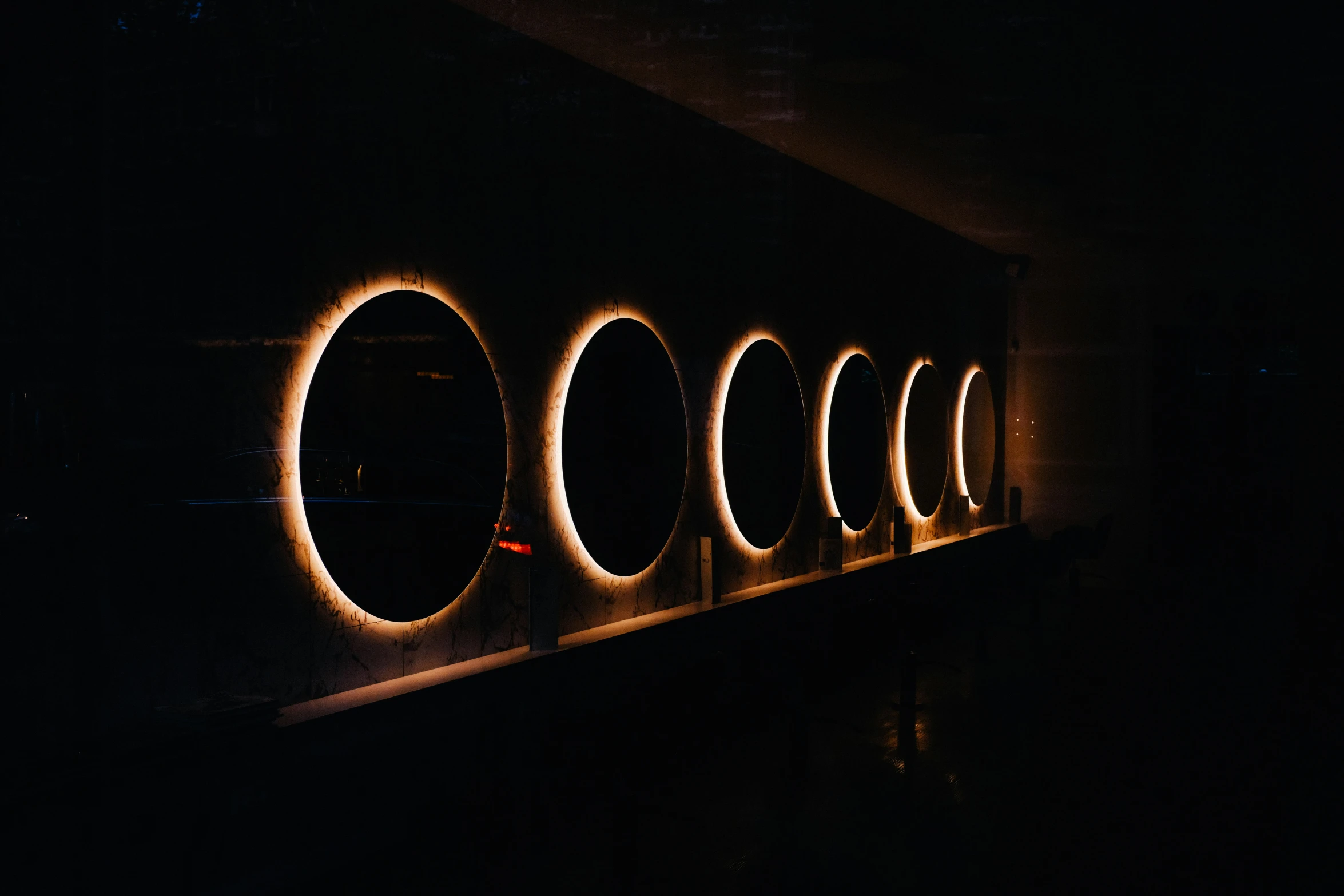 a long wall with circular light inside it
