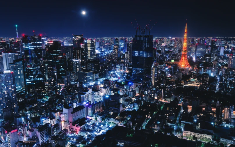 an aerial view of a city at night with the lights on