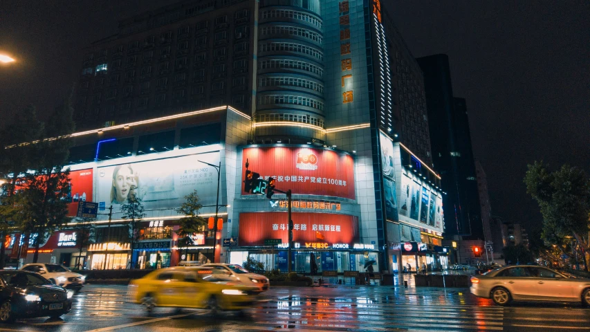 the traffic is driving along on the wet street