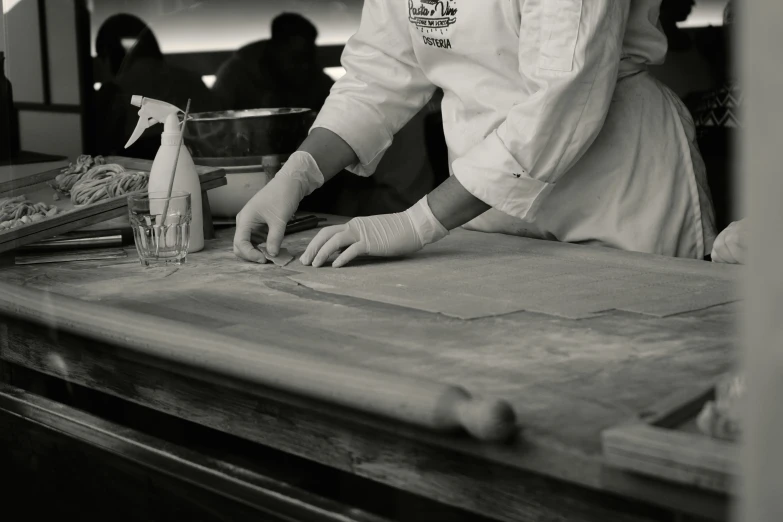 a chef in a kitchen using a bottle of liquid