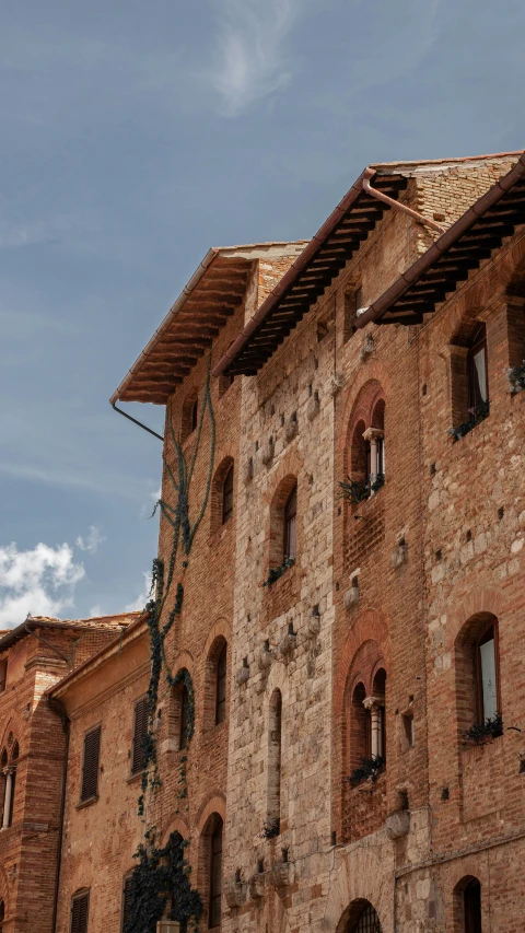 a clock is displayed on the side of an old building