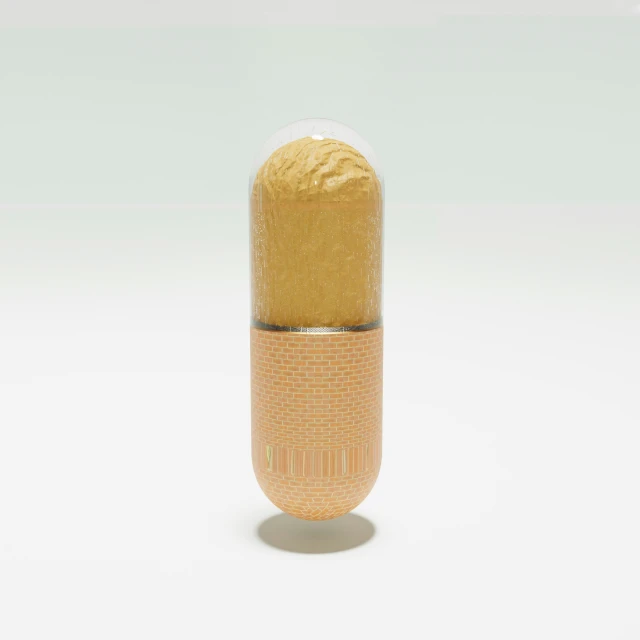 a gold pill with white top on a table