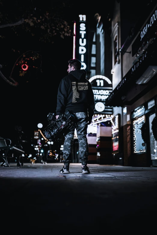 a man standing on the side of a street holding his luggage