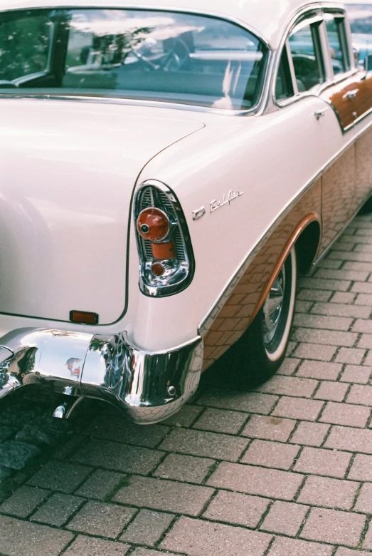 an old white car is parked in a lot