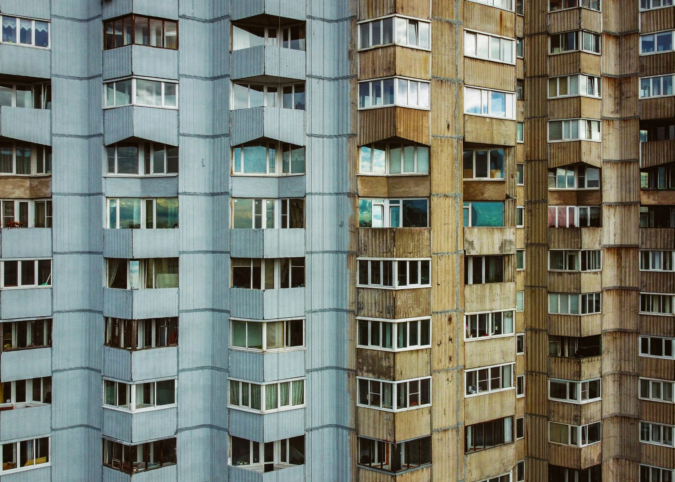 the windows on a tall building are showing through