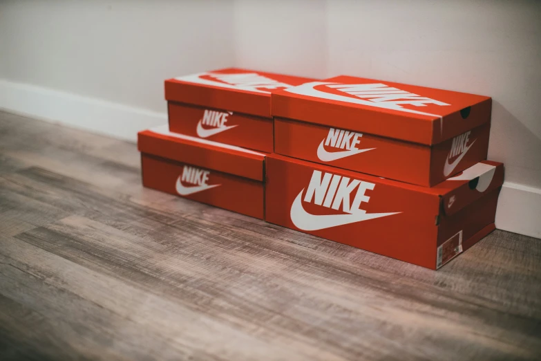 two boxes sitting on the floor and one has a nike