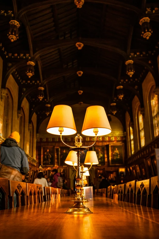 a person sitting in a chair near a table with lamps on top