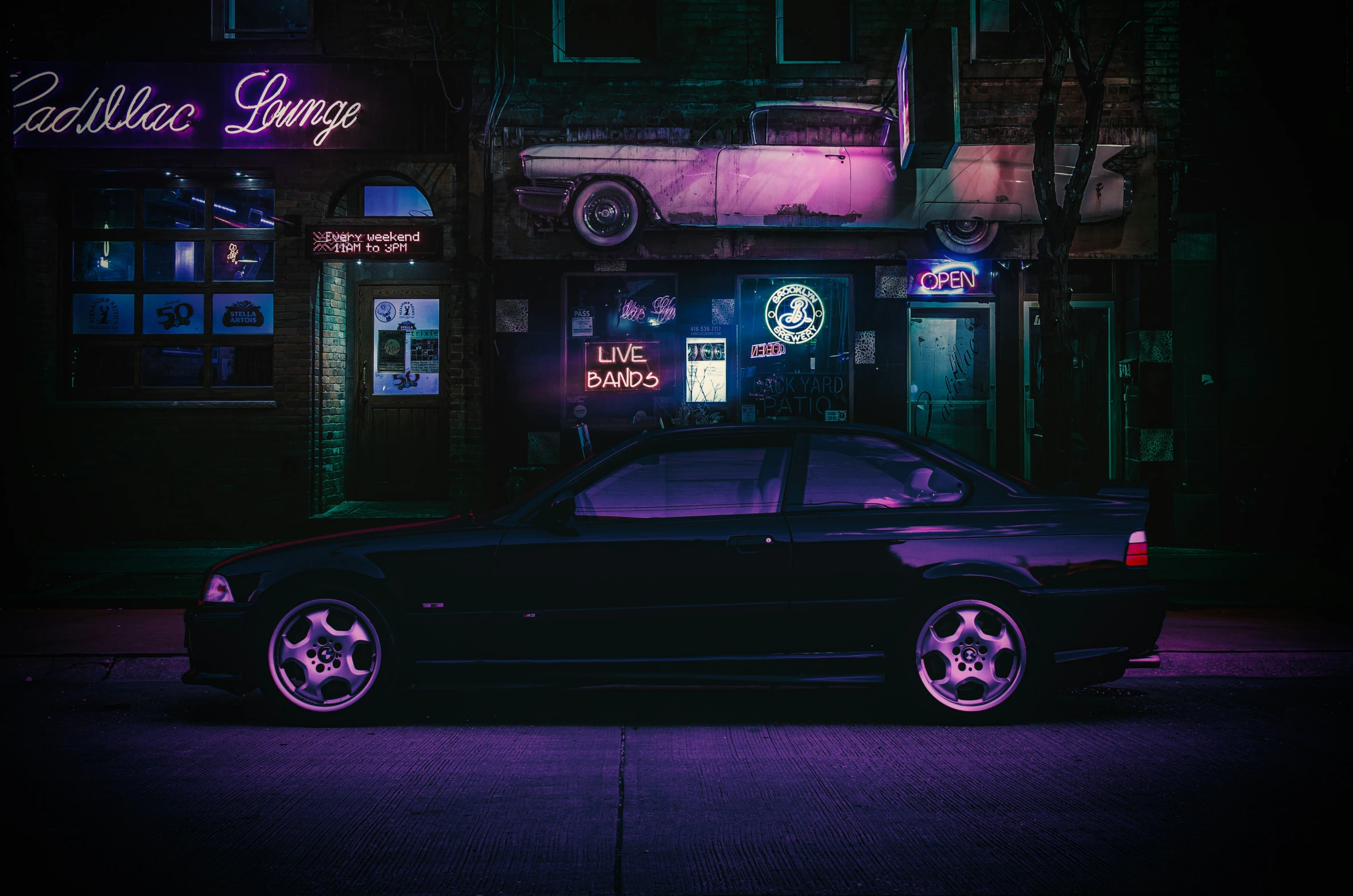 a very dark car parked on the side of the road