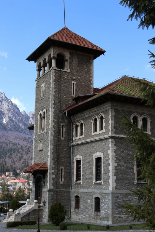 an old stone building with a steeple in the background