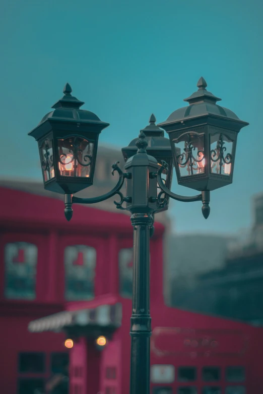 there are two street lamps attached to a lamp post