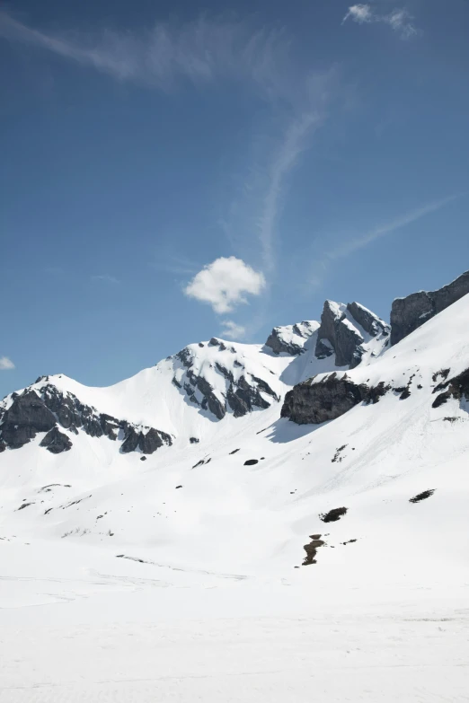 a person riding skis on top of a snowy slope