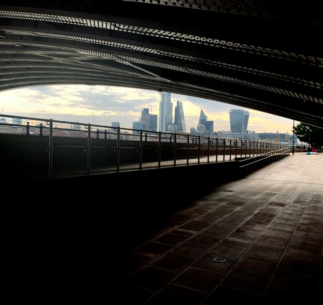 the view from underneath an arch in a city