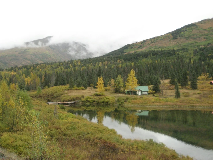 a body of water surrounded by lush green hills