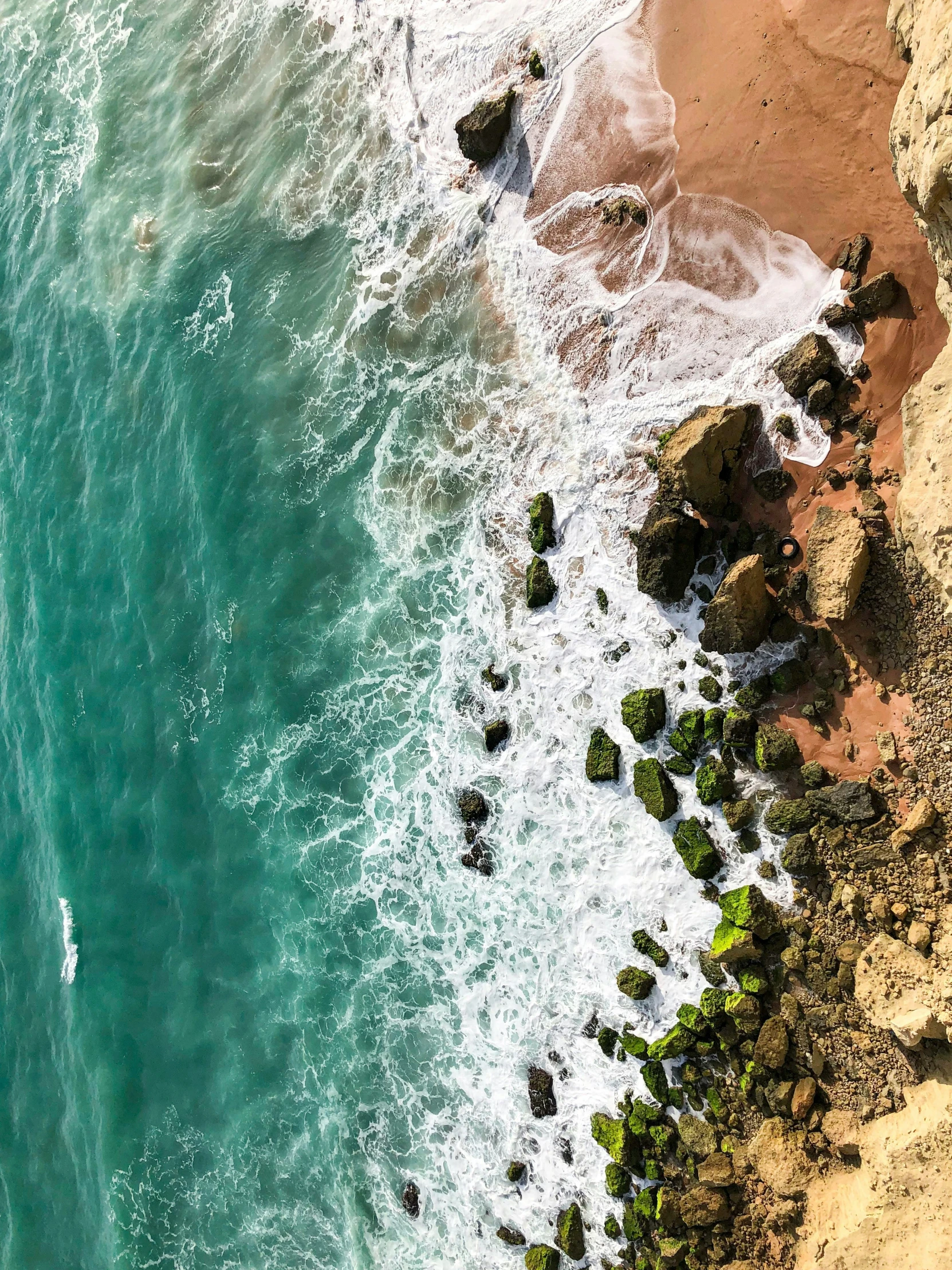 an aerial s of a beach, and some water