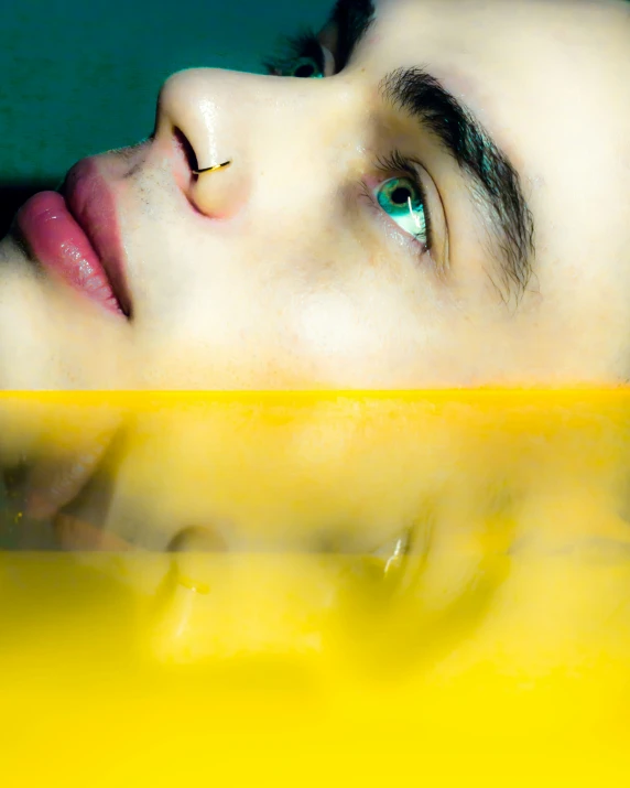 an eyes of a man with a piercing in his ear