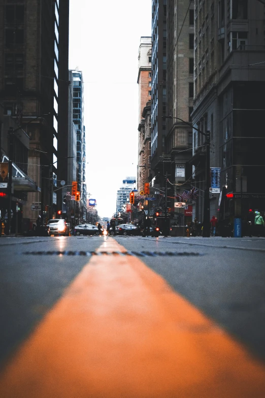 an empty street with cars driving on it