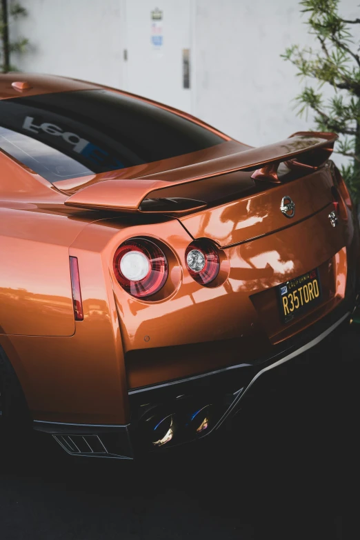 the tail end of a sports car parked on a street