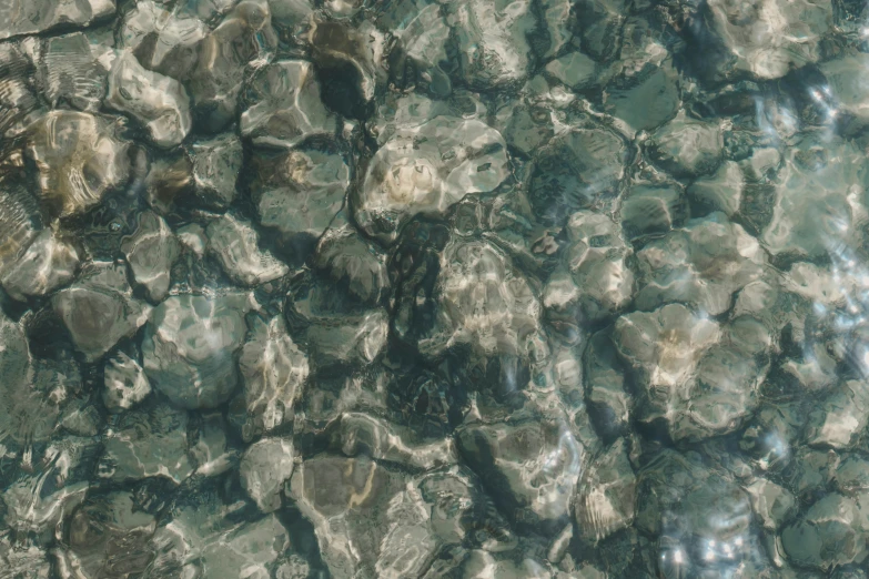 an image of rocks in the water surface