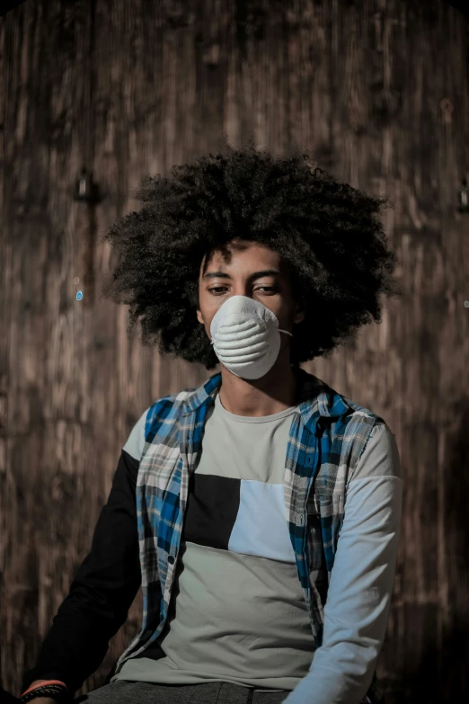 a young man with a face mask and apron