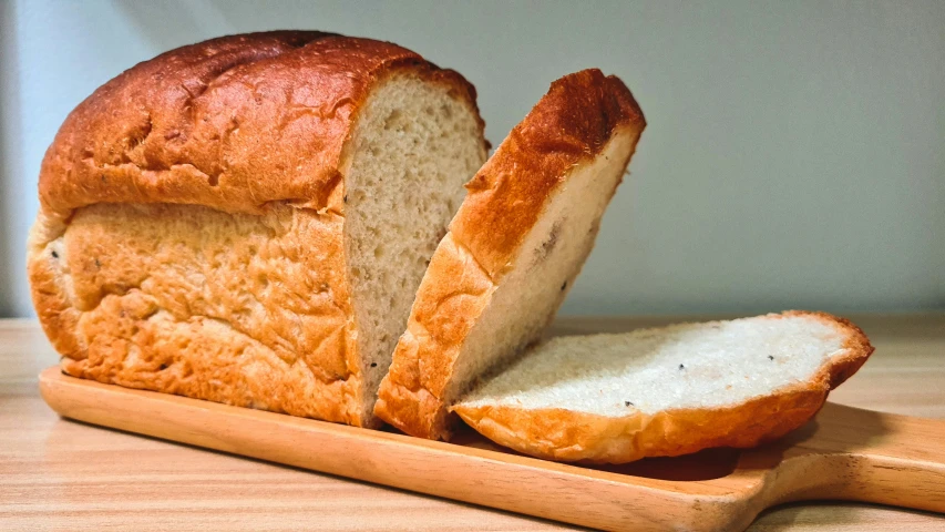 a loaf of bread is sliced on a  board