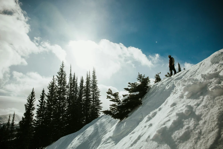 a man snowboarding down the side of a ski slope