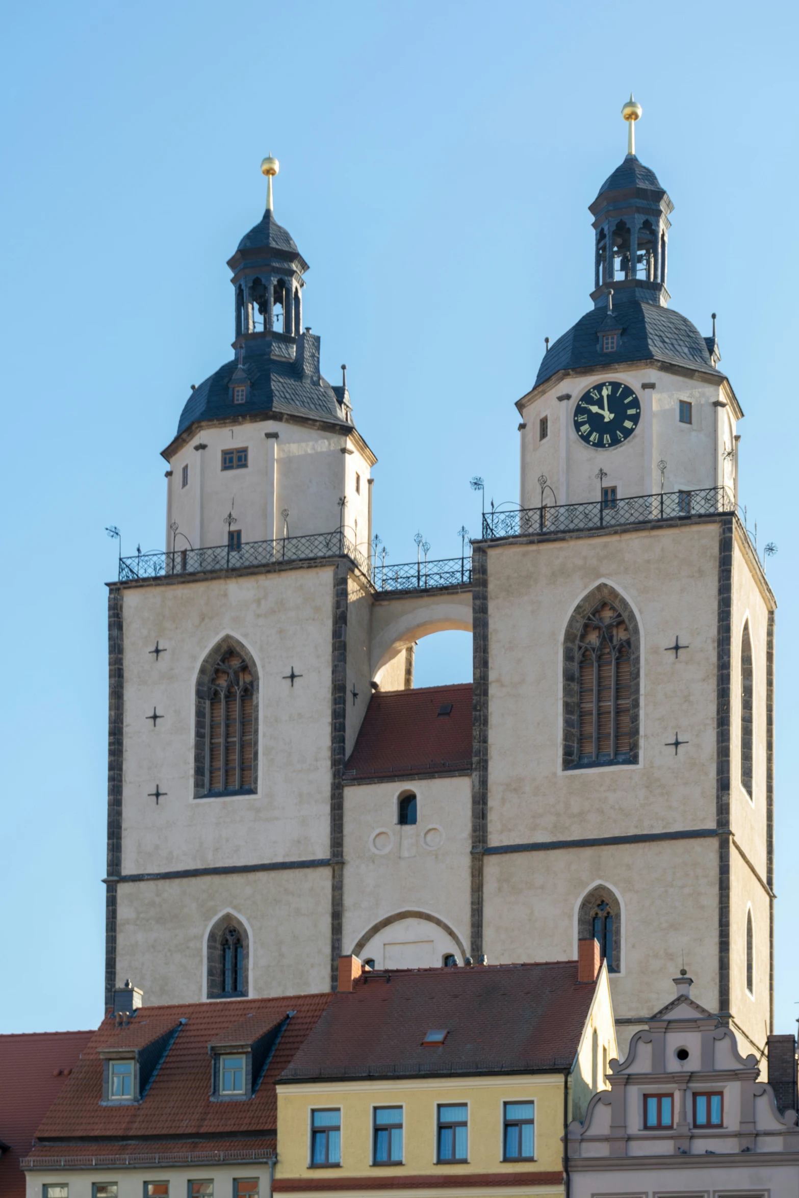 a clock tower with two towers and two towers attached