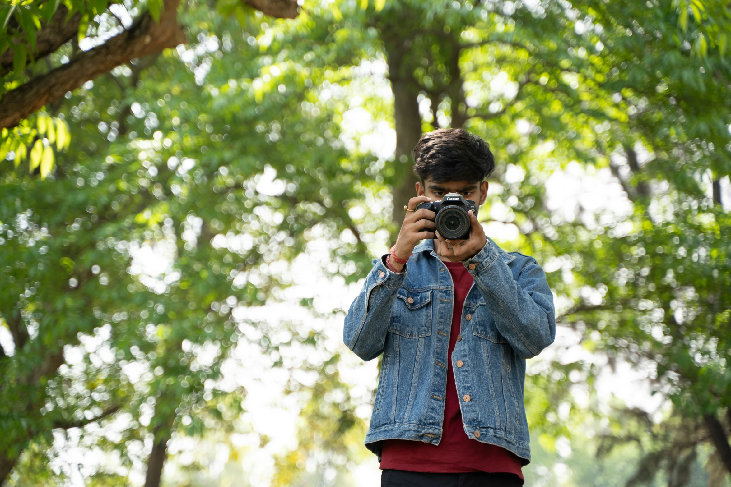 a person standing in a park taking a po