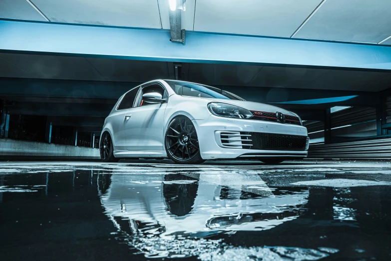 a white car in an indoor parking garage