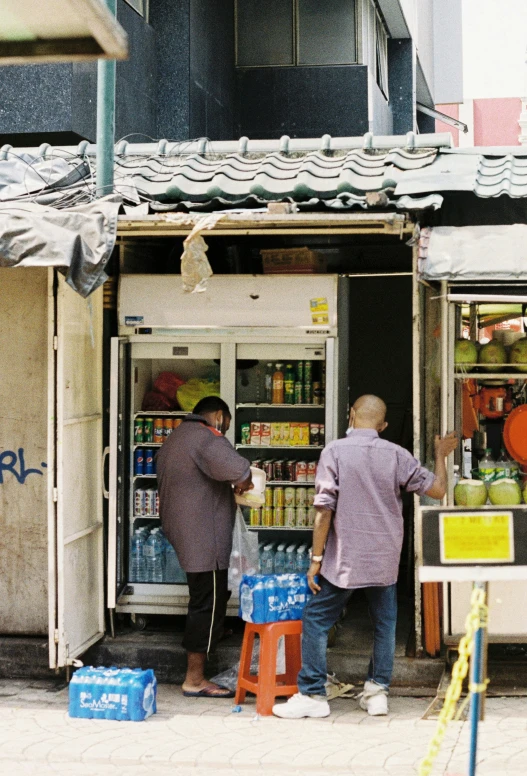 two men in front of a grocery store