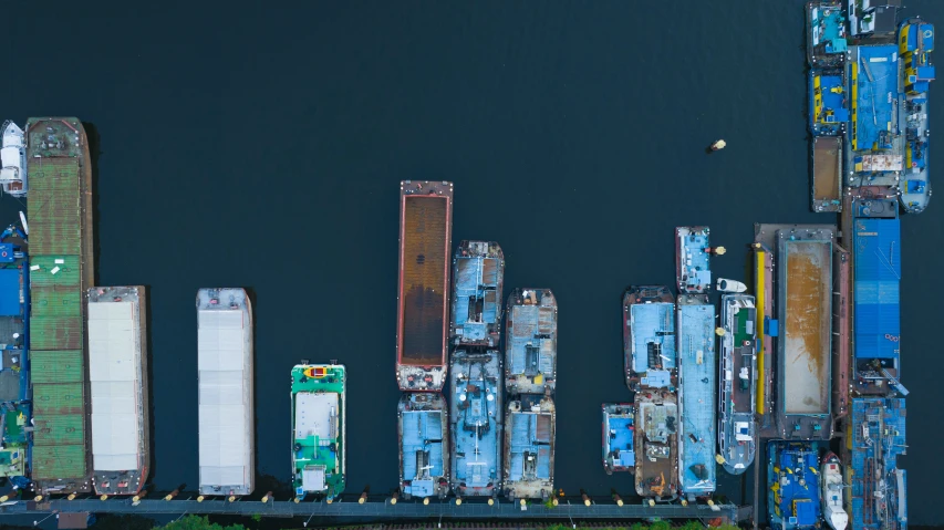 large boats docked at docks near large building with graffiti