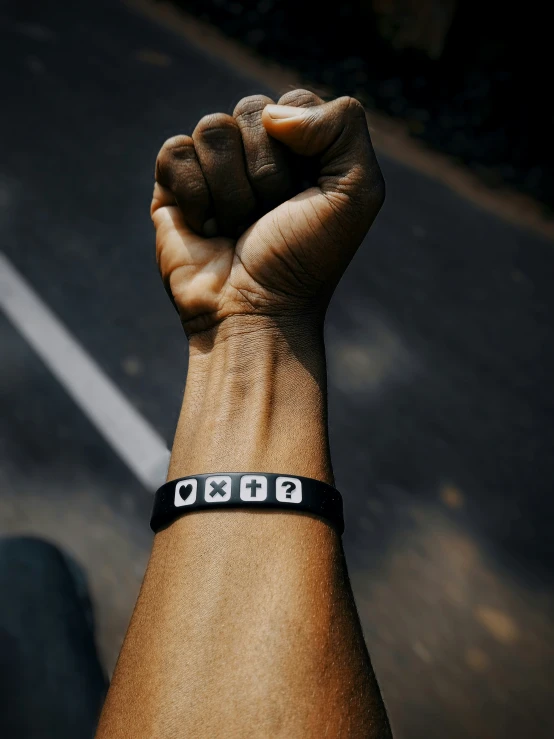 a close up of a person raising their fist