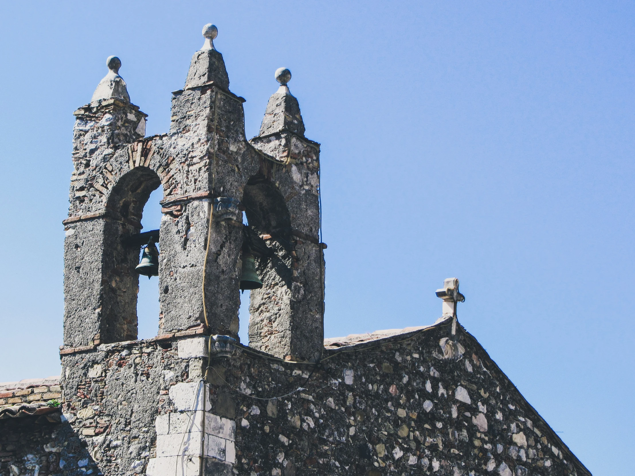 an old church with a bell tower that is broken down