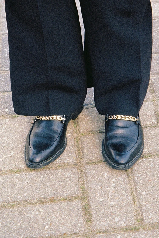 a man in a suit and tie standing on a sidewalk