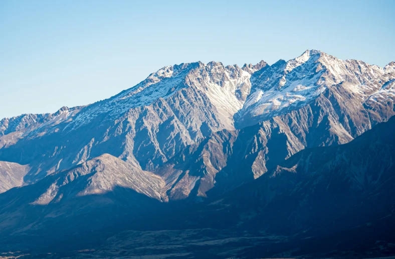 mountains with snow on them in the middle of the day