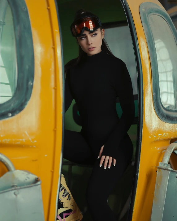 an attractive woman leaning up against the side of a bus