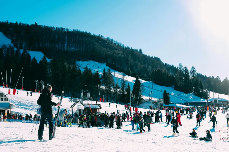 a number of people on skis in the snow near some trees