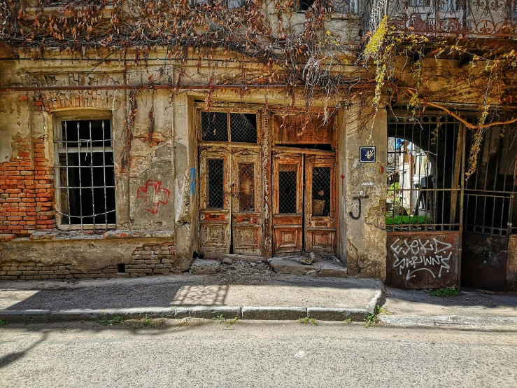 a rusted out old house with boarded up windows