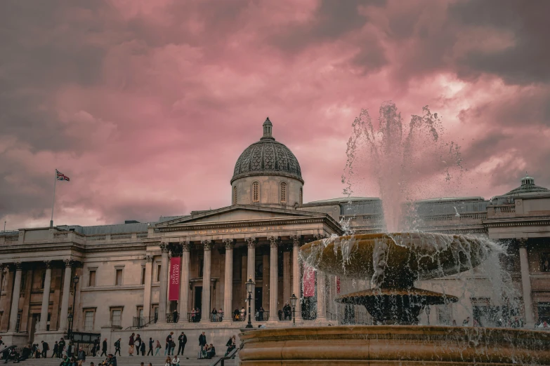 a fountain in front of an old city court house