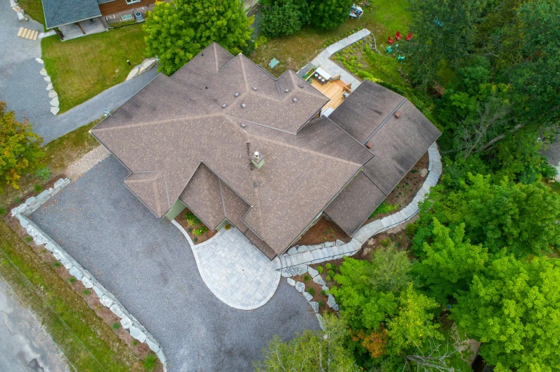 the aerial view of a large home in the forest