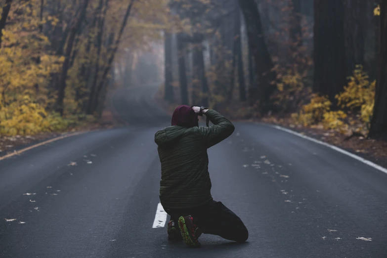 a person sitting on the ground taking a po