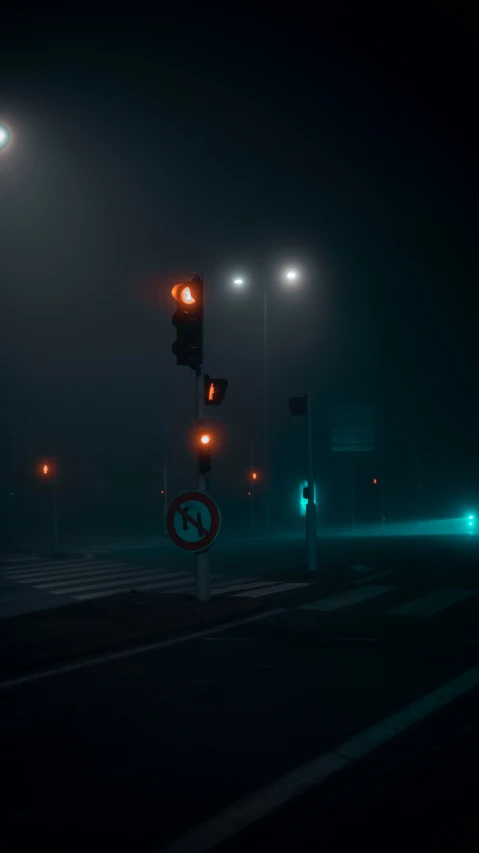 two green light at night on a street corner