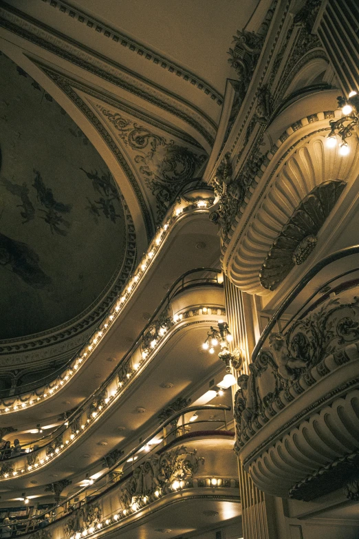 an ornate building has lights on its ceiling