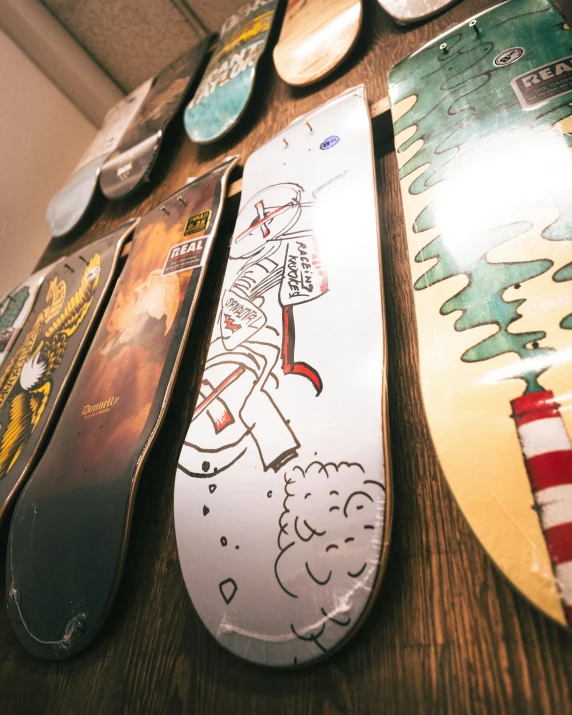 a table topped with lots of different skate boards