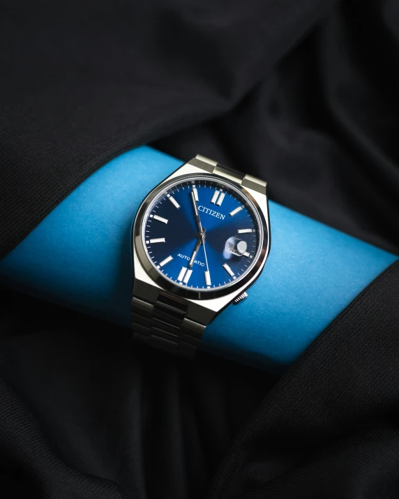 the watch has blue dials on it's hands