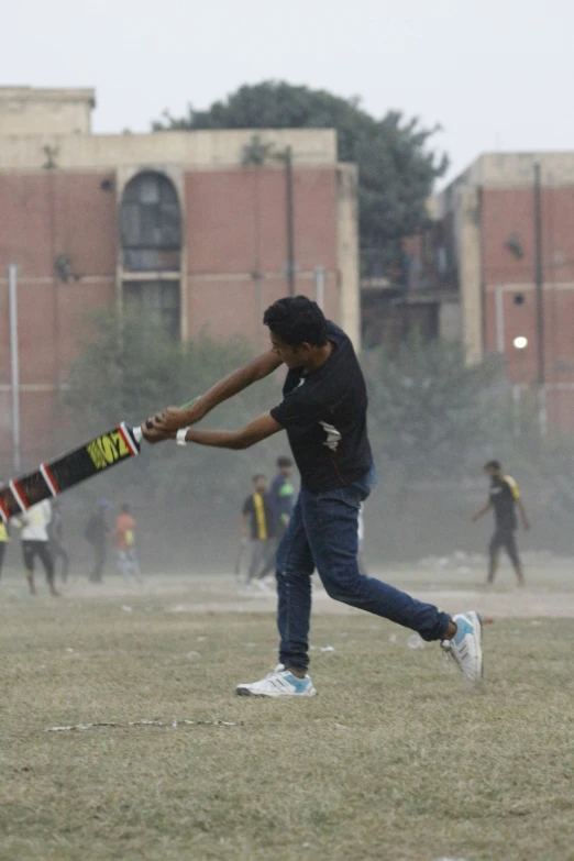 a person hitting a baseball with a bat